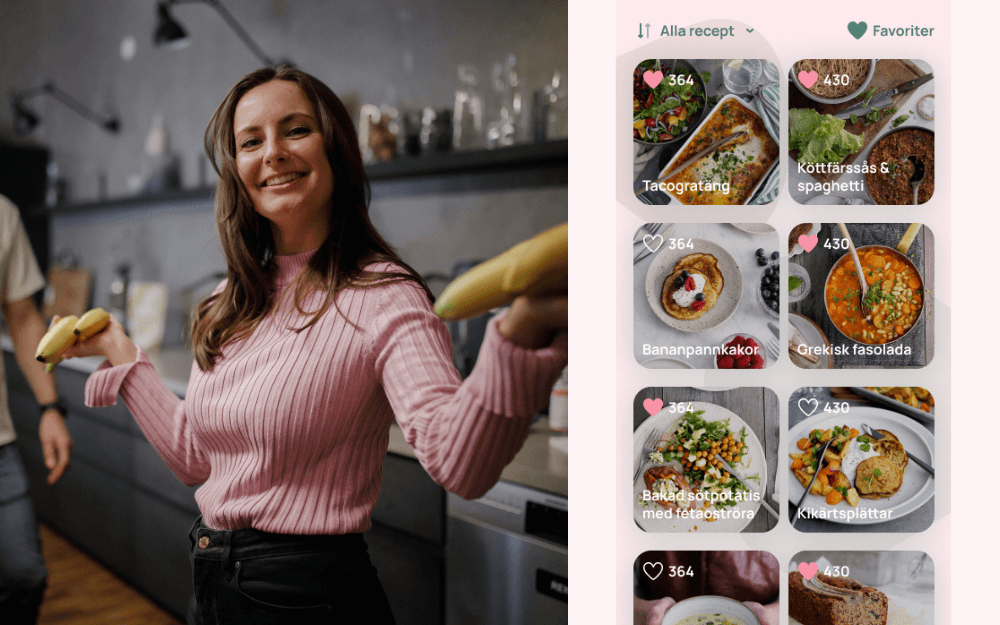 Leende, brunhårig kvinna i rosa tröja står i ett kök med bananer i händerna.